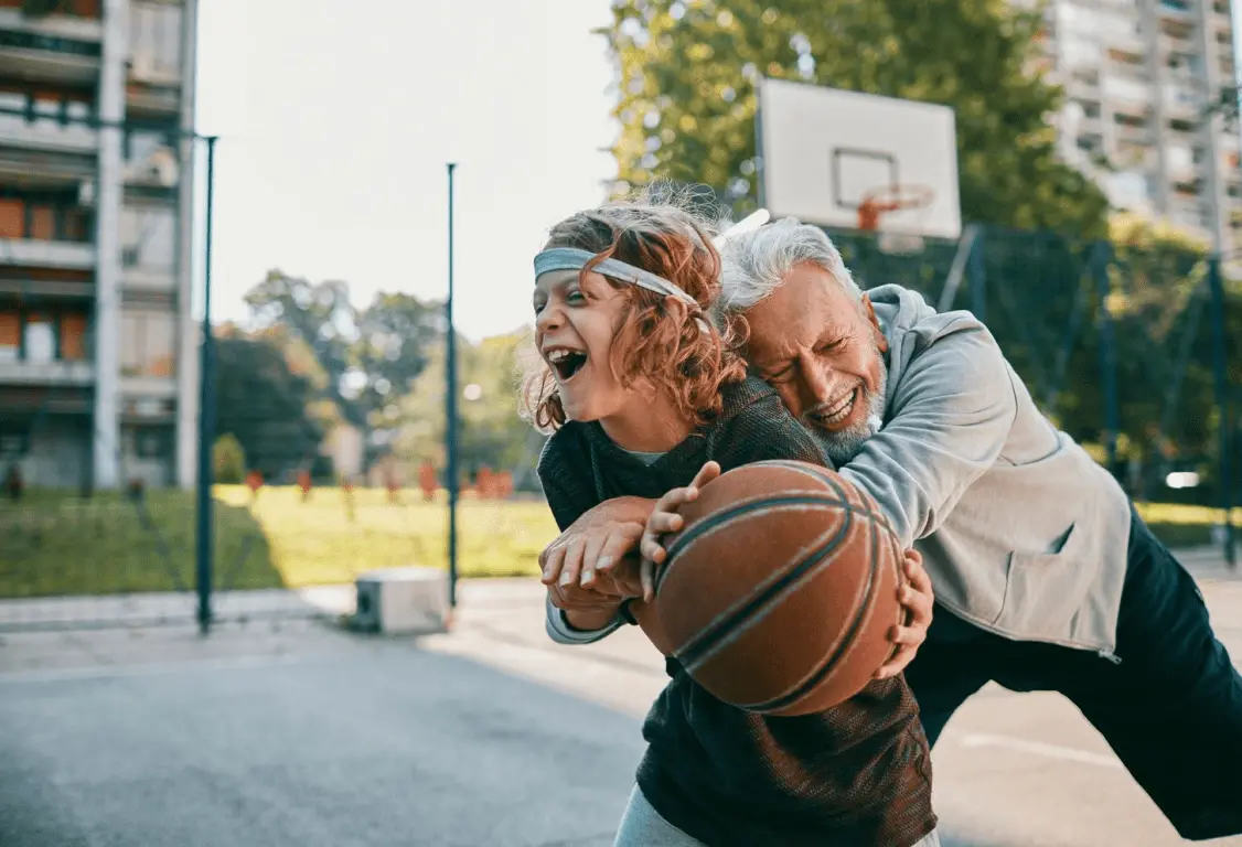 Adult and child playing basket ball